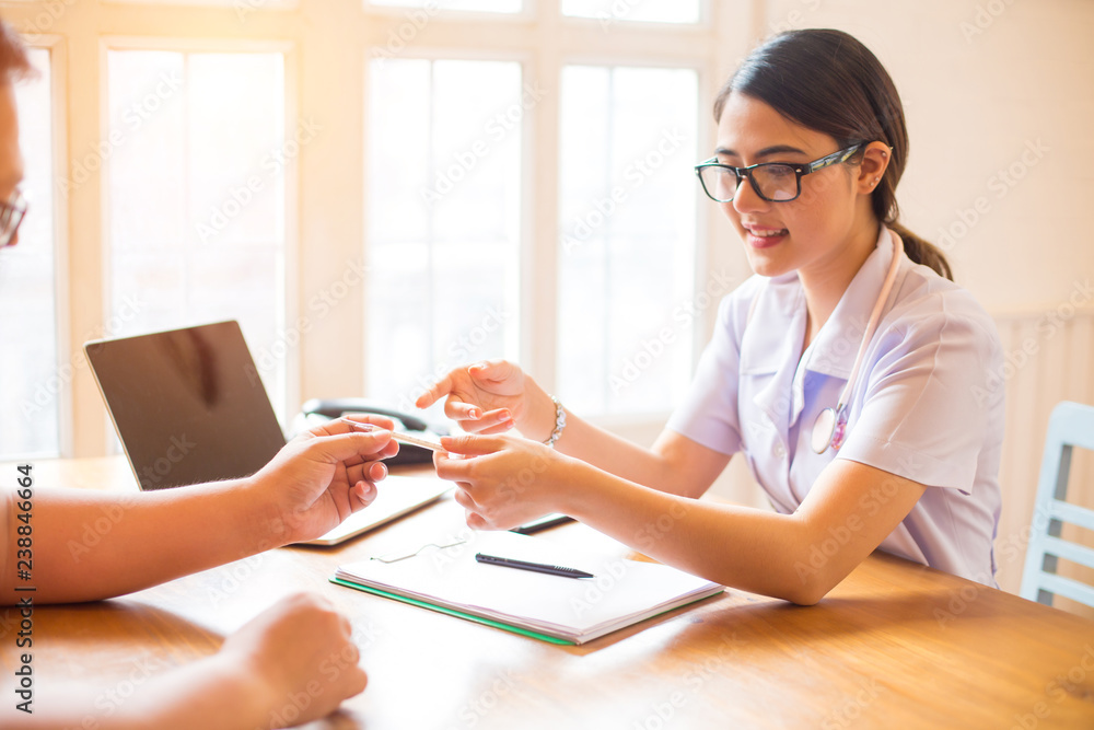 Smiling Two doctors and patient are discussing something