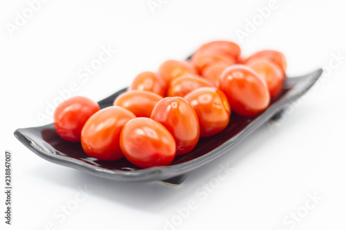 Photos Fresh Tomato in a ceramic cup isolated white background