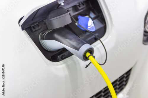 the charging the battery for the car new Automotive Innovations the power supply plugged into an electric car being charged, concept of energy innovation.