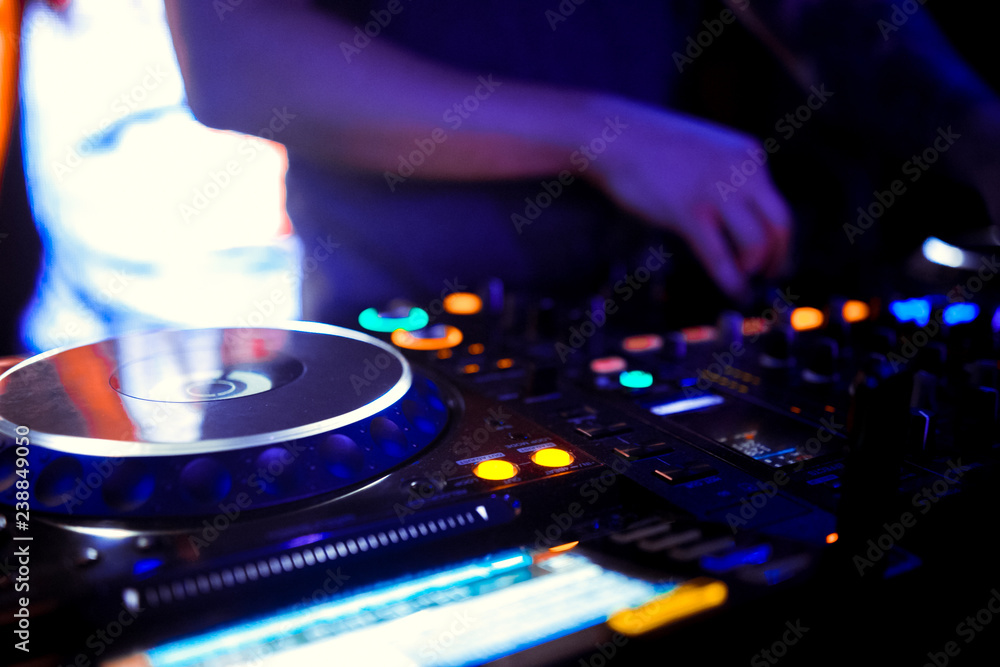 Naklejka premium DJ console cd mp4 deejay mixing desk Ibiza house music party in nightclub with colored disco lights.