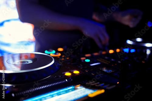 Dj mixes the track in the nightclub at party