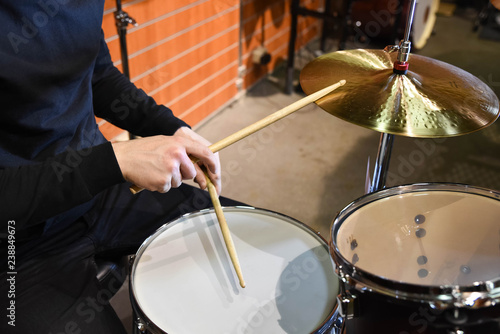  Professional drum set closeup. Man drummer with drumsticks playing drums and cymbals, on the live music rock concert or in recording studio 