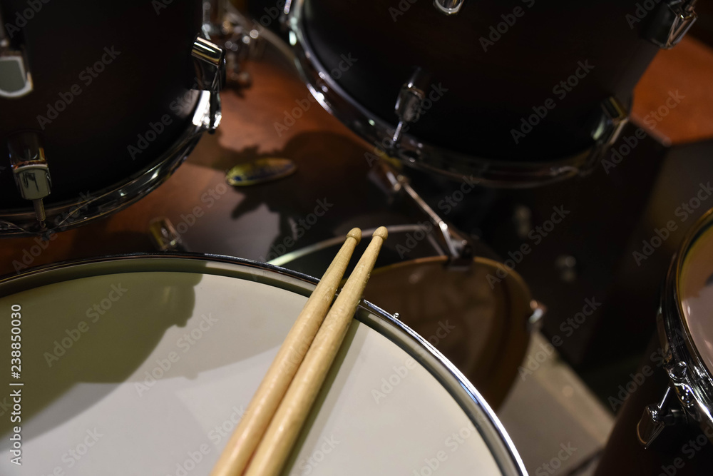 Closeup of drumsticks lying on the professional drum set. Drummer equipment. Closeup of drumsticks lying on the professional drum set. Drummer equipment.