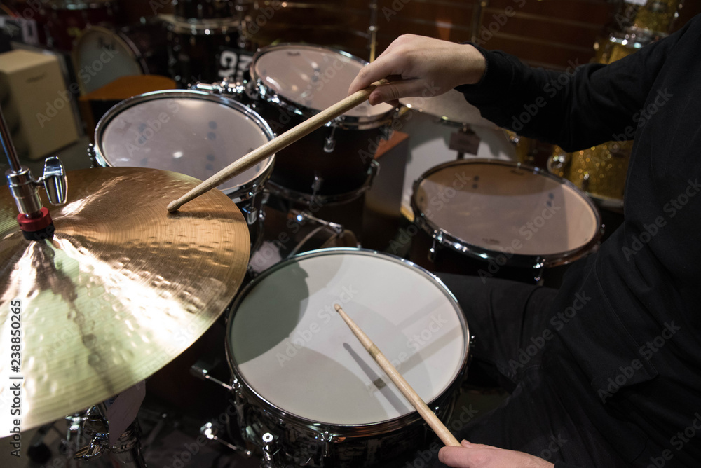 Professional drum set closeup. Man drummer with drumsticks playing drums and cymbals, on the live music rock concert or in recording studio Professional drum set closeup. Man drummer with drumsticks playing drums and cymbals, on the live music rock concert or in recording studio