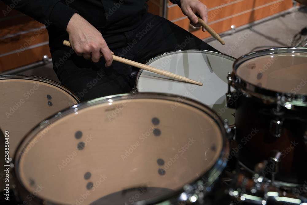Obraz premium Professional drum set closeup. Man drummer with drumsticks playing drums and cymbals, on the live music rock concert or in recording studio 