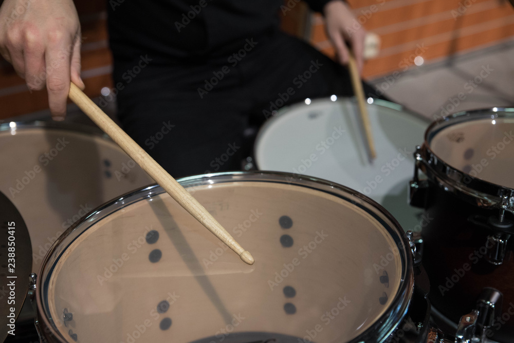 Professional drum set closeup. Man drummer with drumsticks playing drums and cymbals, on the live music rock concert or in recording studio Professional drum set closeup. Man drummer with drumsticks playing drums and cymbals, on the live music rock concert or in recording studio