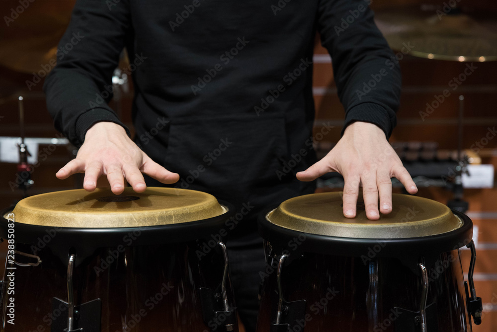 Professional percussion drum set closeup. Man drummer playing kongo ...