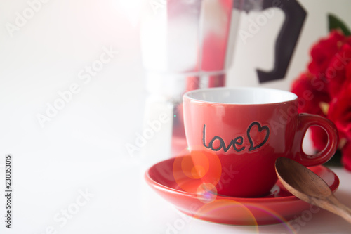 Close up red coffee cup on white background with red rose and coffee pot