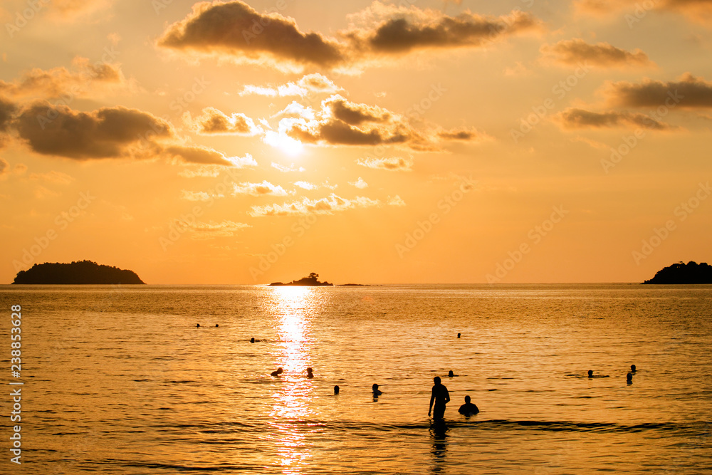 Peoples to swim in the sea on sunset background. concept about people and fun, freedom, vacation