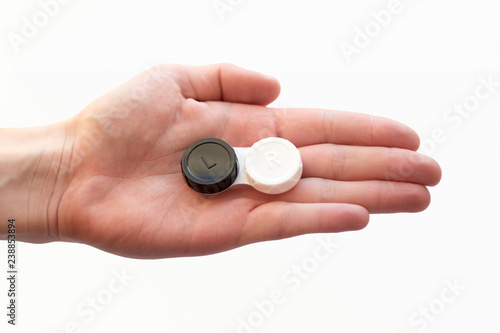 woman hand is holding contact lens case