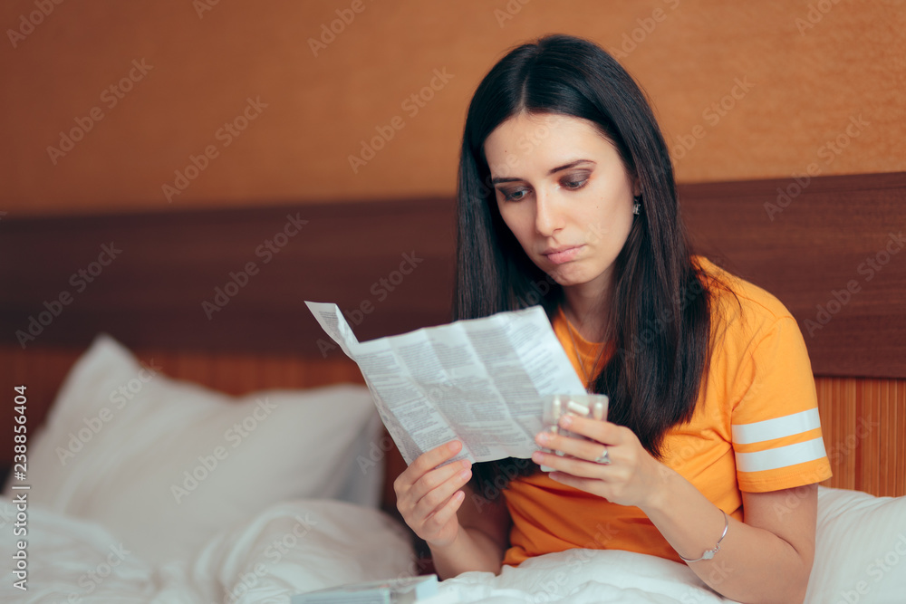 Woman Reading Medicine Leaflet Before Taking Pills Woman Reading Medicine Leaflet Before Taking Pills