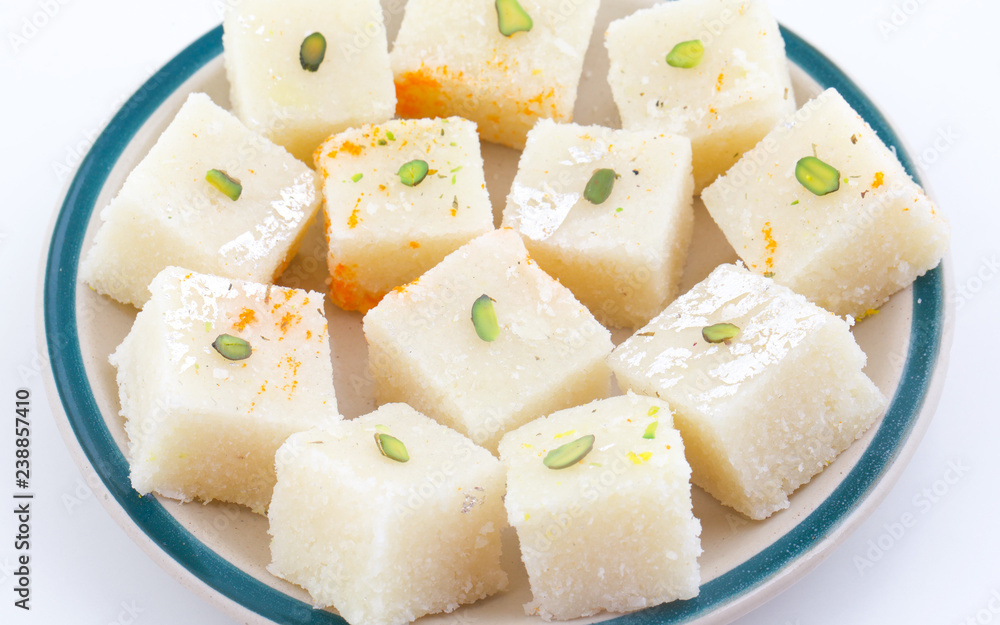 Indian Popular Sweet Food Khopara Pak or Coconut Burfi made up of Coconut, Milk And Sugar Isolated on White Background Indian Popular Sweet Food Khopara Pak or Coconut Burfi made up of Coconut, Milk And Sugar Isolated on White Background