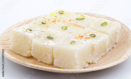 Indian Popular Sweet Food Khopara Pak or Coconut Burfi made up of Coconut, Milk And Sugar Isolated on White Background