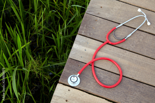 stethoscope red on wood outdoor