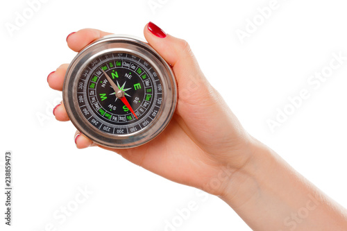 Woman holding small compass. Isolated in a white background.