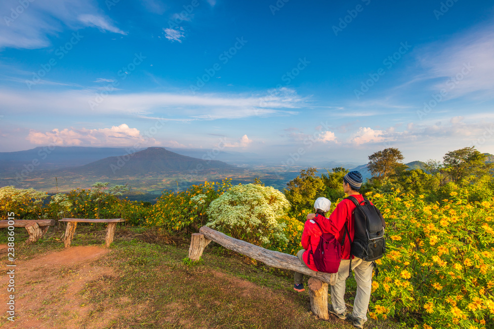 The lovers  in red jacket touring on the beautiful mountain.