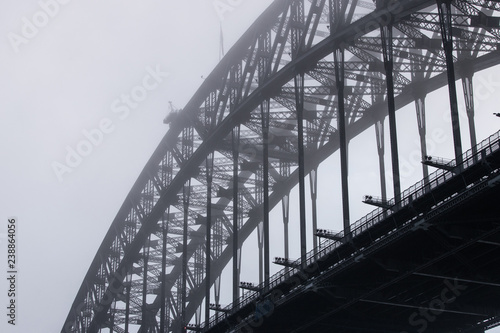 Close-up view of Sydney Harbour Bridge in a foggy morning.