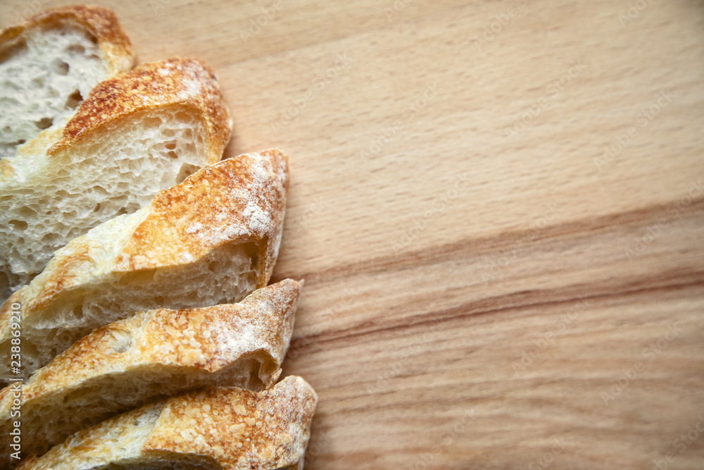 Sliced bread on a wooden table. Sliced bread on a wooden table.