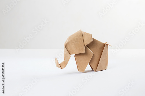 Brown paper origami elephant isolated on white background