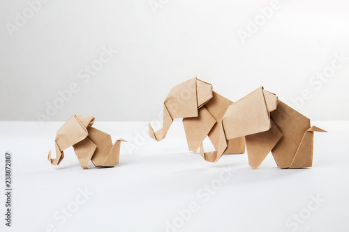 Brown paper elephant family in origami tehnique isolated on white background photo