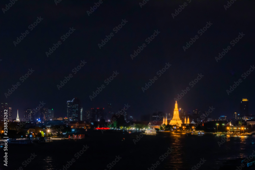 Wat Arun at night with gold and is the oldest temple of the Chao Phraya River. in Bangkok Thailand.