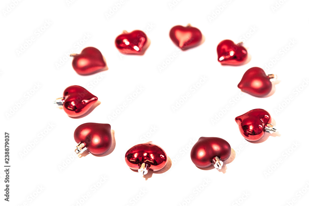 circle of red Christmas decorations in shape of heart on white background circle of red Christmas decorations in shape of heart on white background