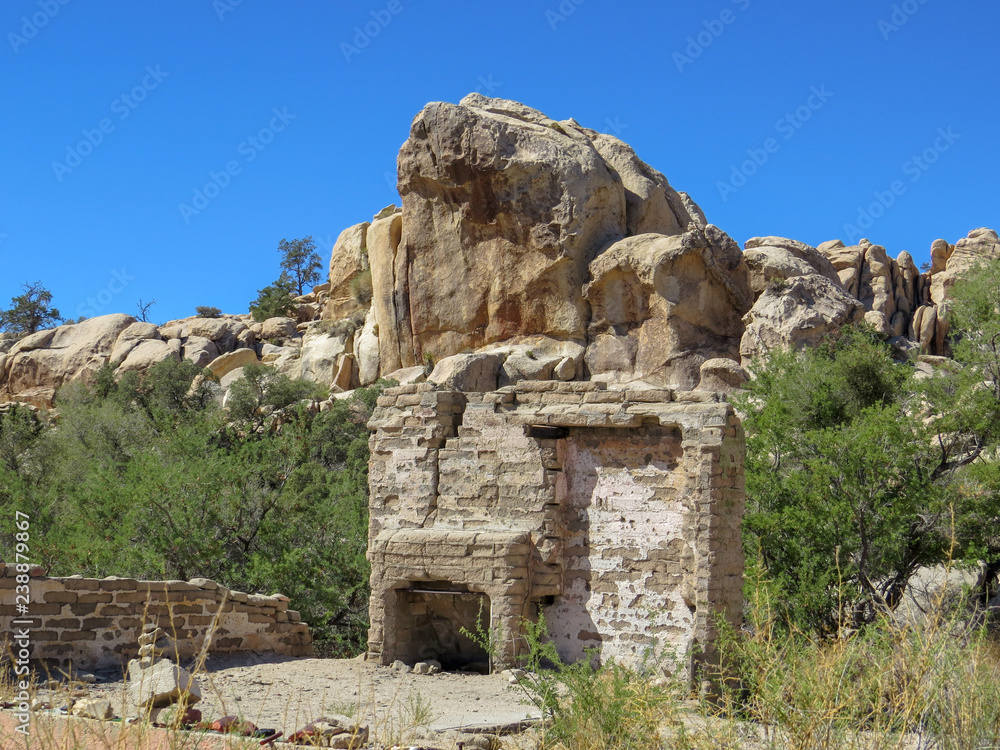 Ruined fireplace and walls in scenic desert valley