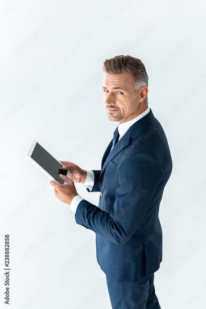 high angle view of handsome businessman holding tablet with blank screen and looking at camera isolated on white high angle view of handsome businessman holding tablet with blank screen and looking at camera isolated on white