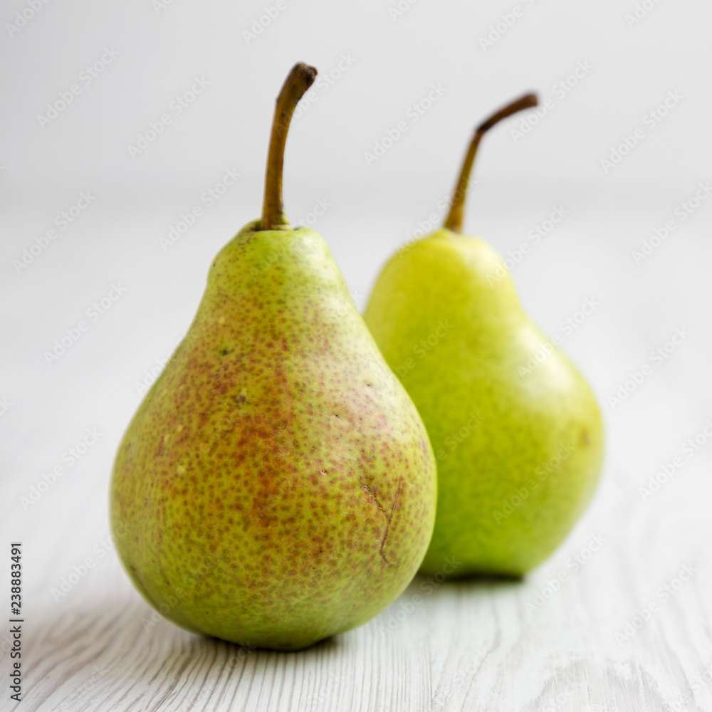 Fresh pears on a white wooden background, side view. Closeup. Fresh pears on a white wooden background, side view. Closeup.