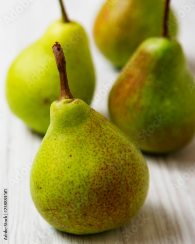 Fresh organic pears on a white wooden background, side view. Close-up.