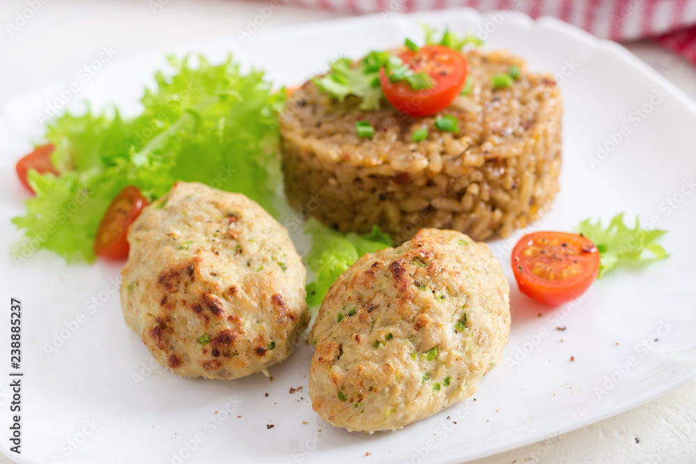 Homemade baked cutlets with rice on a table in a rustic style. Healthy food Homemade baked cutlets with rice on a table in a rustic style. Healthy food
