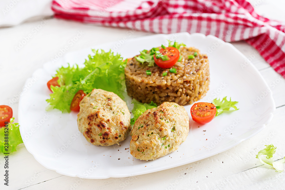 Homemade baked cutlets with rice on a table in a rustic style. Healthy food Homemade baked cutlets with rice on a table in a rustic style. Healthy food