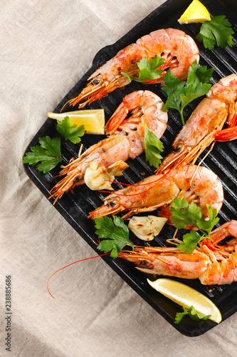 Grilled shrimps with spice, garlic and lemon. Grilled seafood. Langoustines.