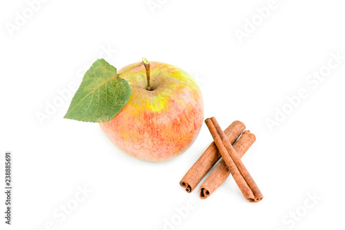 Apples with leaves and cinnamon sticks isolated on white background.
