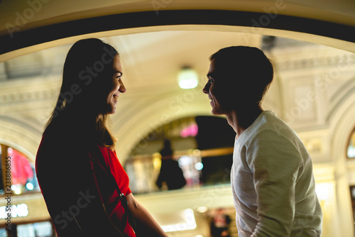young happy smiling male and female talk each other indoors  f © Mihail