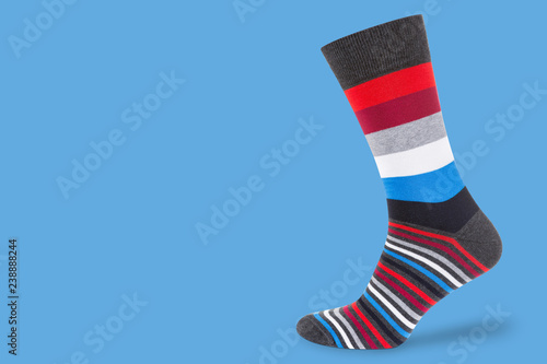 socks with multicolor stripes on a pastel blue background, concept