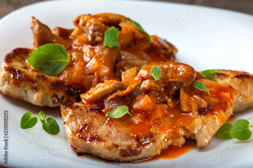 Fried pork chops with vegetables sauce and herbs