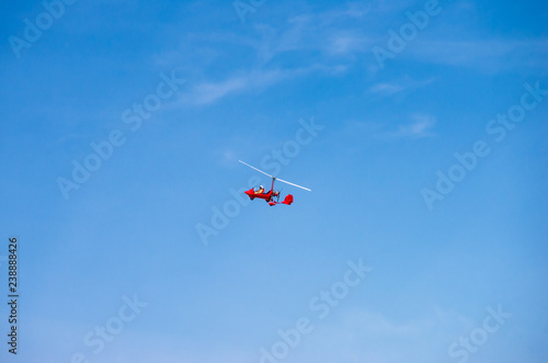 red helicopter flying in an airshow