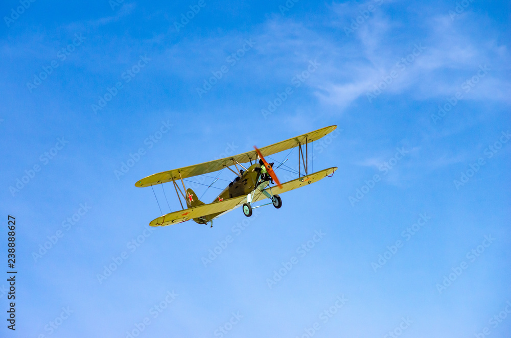 a green old plane flying in an air show a green old plane flying in an air show