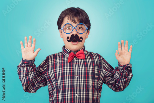 Funny boy with fake mustache and tie