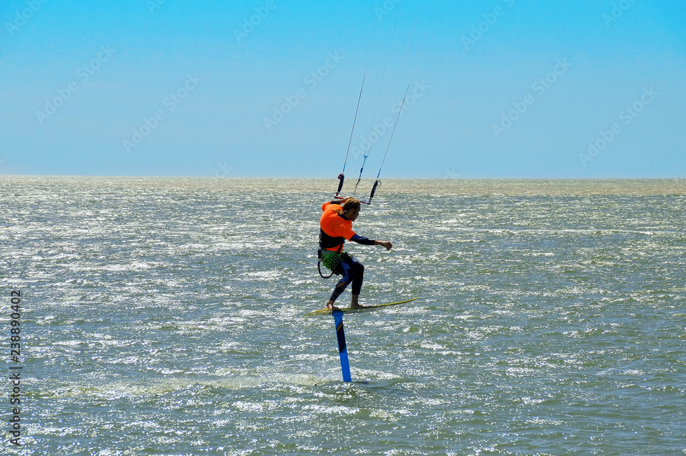 kitesurfing or kiteboarding, the athlete at the time of a jump above the surface of the water
