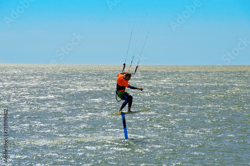 kitesurfing or kiteboarding, the athlete at the time of a jump above the surface of the water