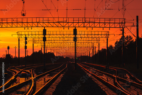 Dark Silhouettes Railway Infrastructure In Dramatic Sunset Backl