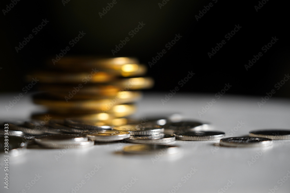 Macro shot detail of golden and silver color coin stacks on dark background with copy space for text. Business and finance growth, saving money, investment and interest concept. Macro shot detail of golden and silver color coin stacks on dark background with copy space for text. Business and finance growth, saving money, investment and interest concept.
