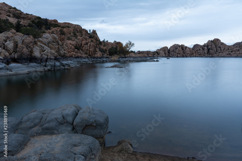 long exposure of The Dells rock formations at Watson Lake in Prescott, Arizona on a gray sky morning with dramatic clouds