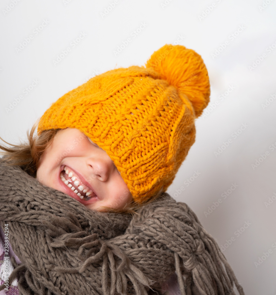 Close up face portrait of toothy smiling young woman wearing knitted hat and scarf. Close up face portrait of toothy smiling young woman wearing knitted hat and scarf.