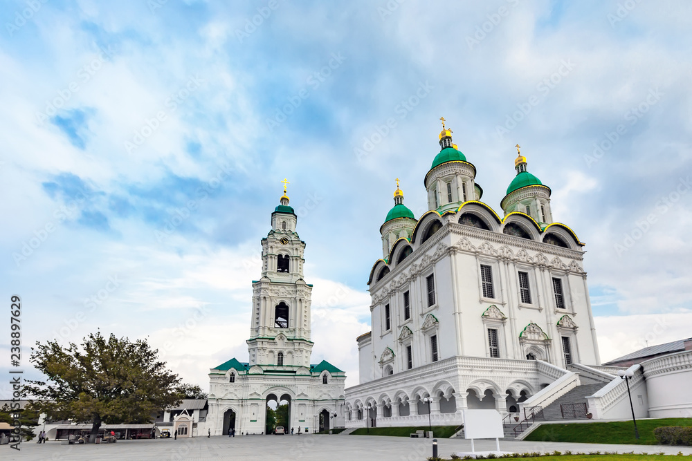 Assumption Cathedral of the Blessed Virgin Mary, snow white christian church, in cold summer weather under thick clouds or veil. Historical and architectural complex Astrakhan Kremlin, Russia.