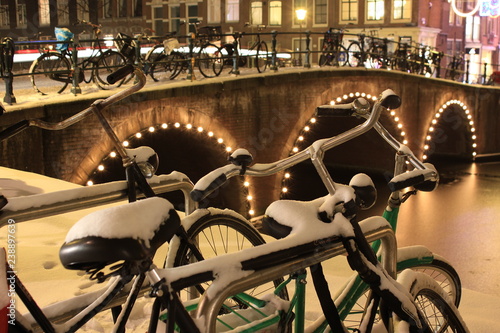 Photography bikes in Amsterdam covered in snow at night