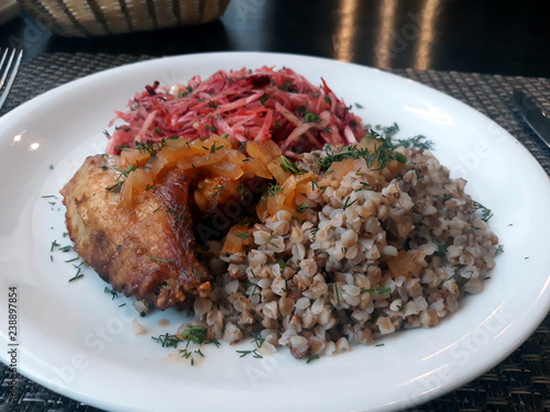 European food. Lunch from buckwheat, salad and chicken wing.