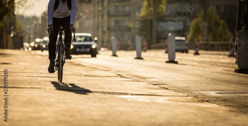 Bikers on a city street in warm evening sunlight